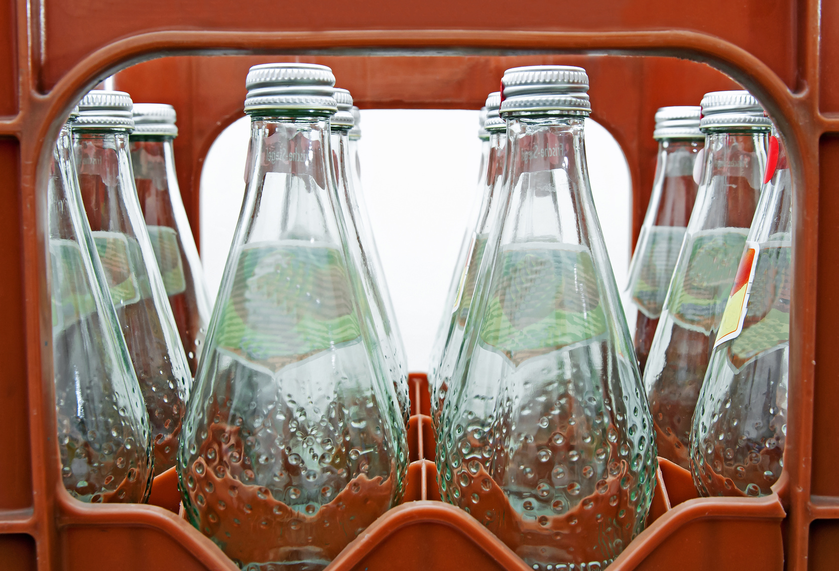 returnable glass bottles with mineral water in a crate
