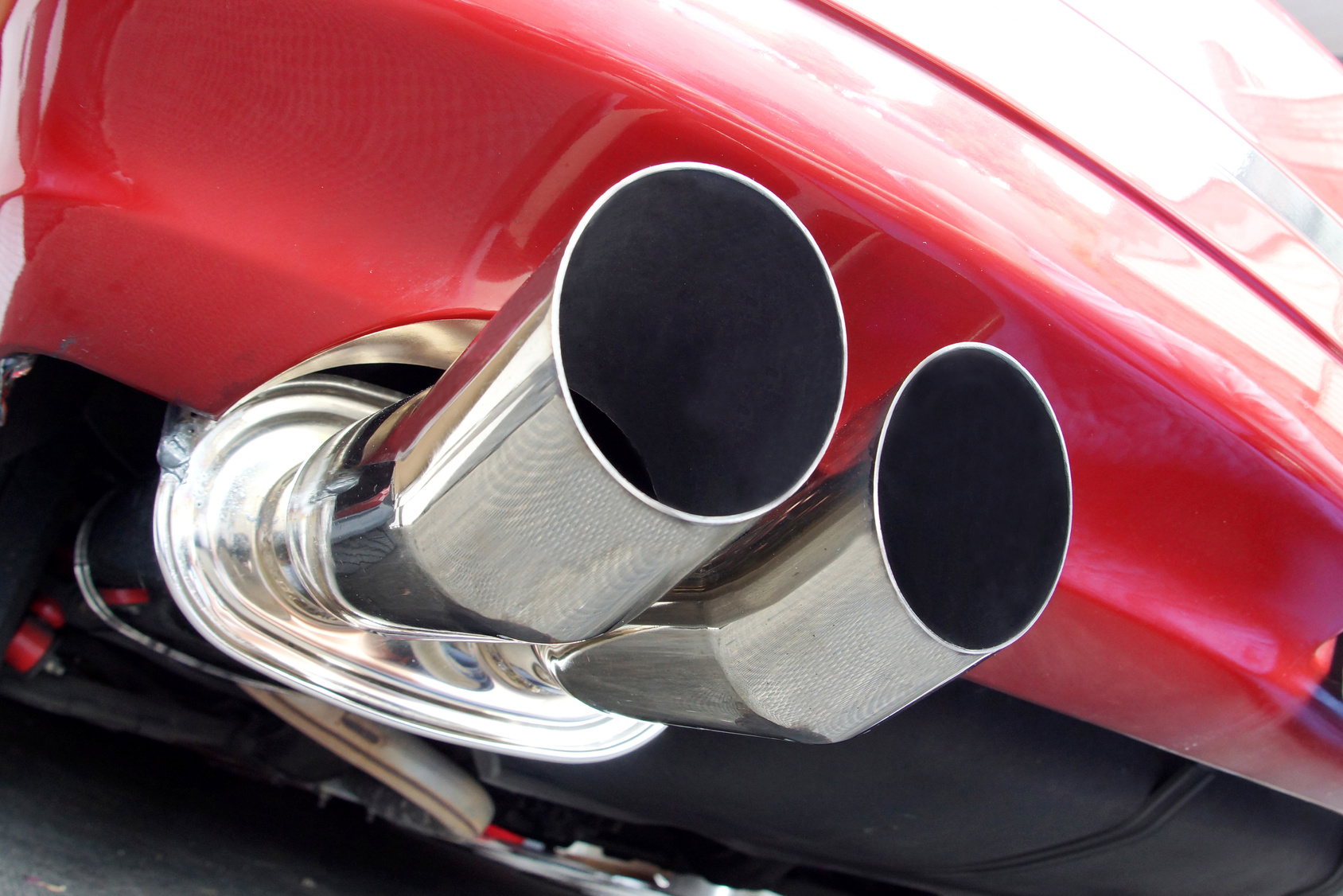 red car with silver exhaust in close-up