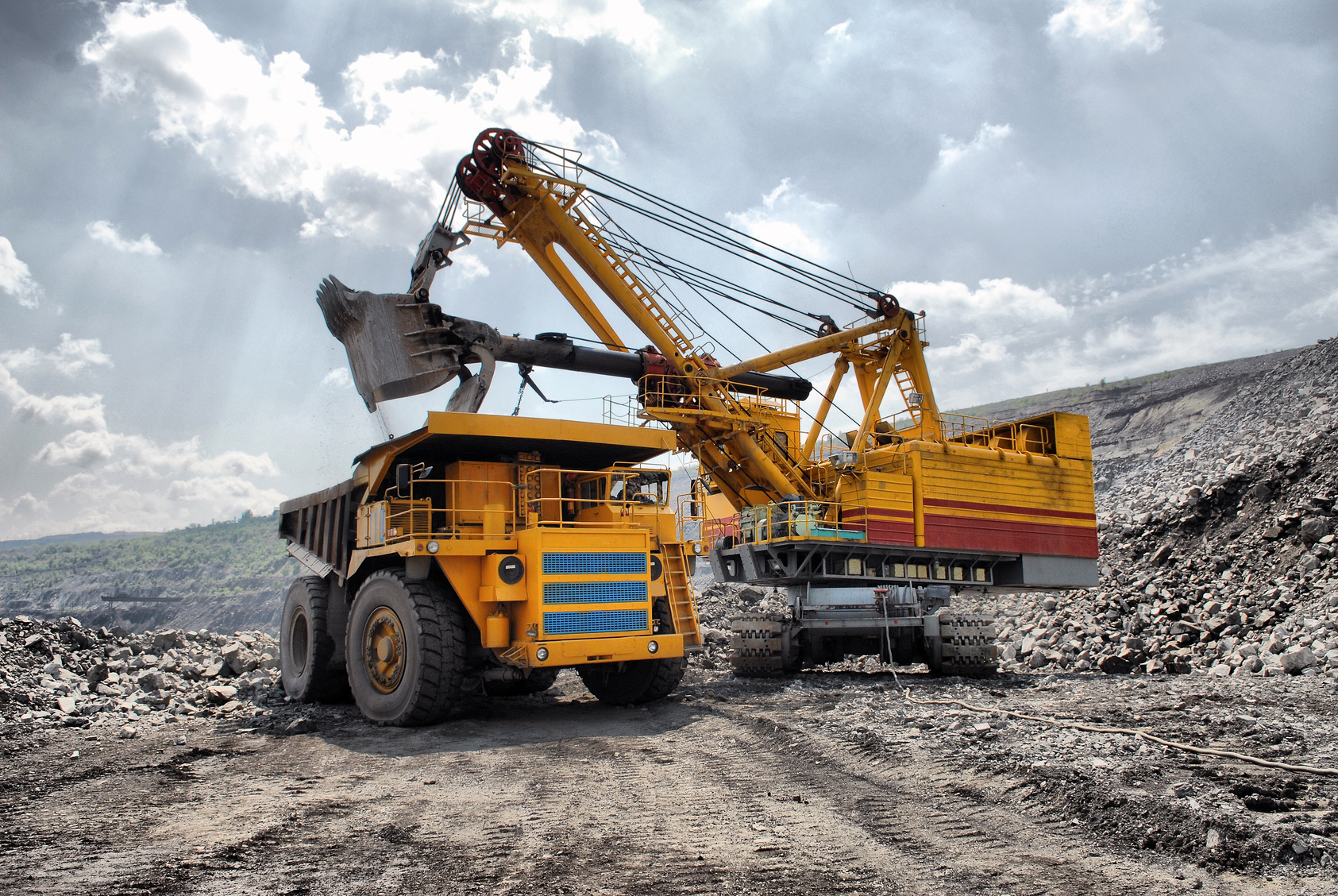 Truck and excavator for the degradation abiotic raw materials