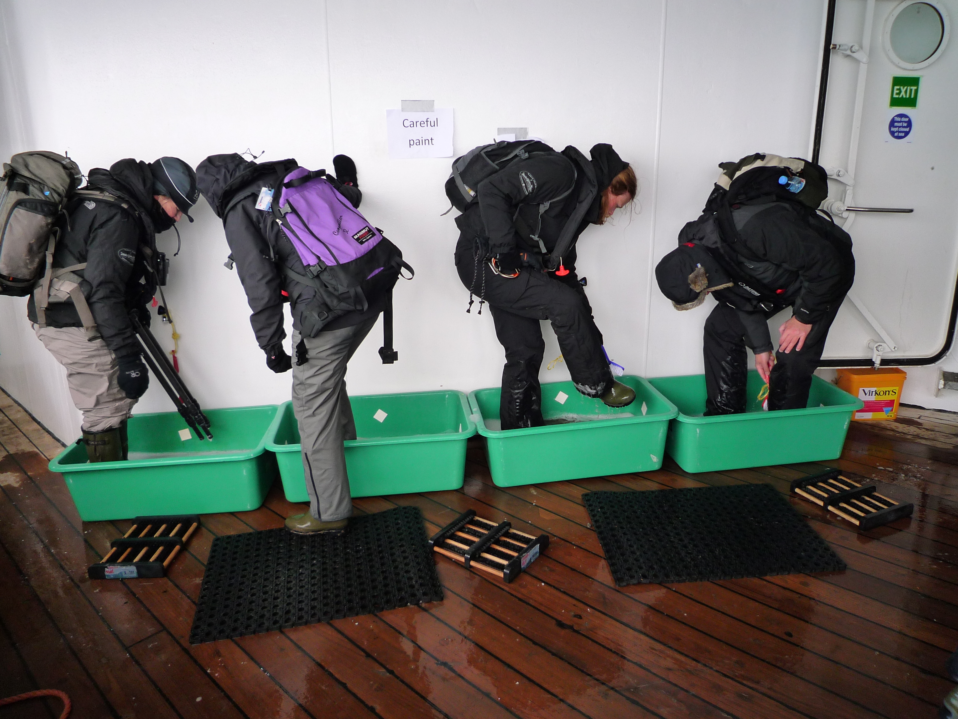 4 persons cleaning the boots