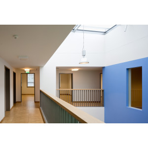 Flure mit Holzfußböden auf einer Galerie, weiße und blaue Wandflächen