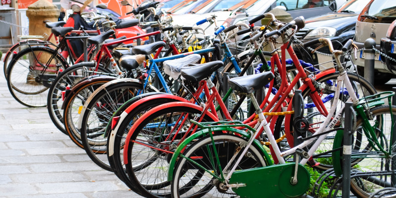 a lot of colourful bicycles in a bicycle stand
