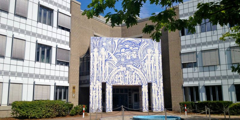 Modern, three-storey office building with large distinctive entrance portal