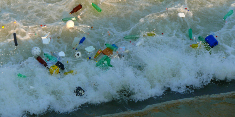 plastic bottles and other pieces of waste in the sea
