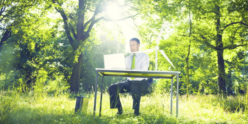 a man sits outside at the desk