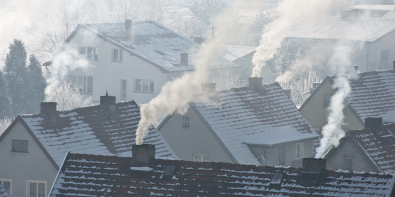 different houses, covered with snow, with smoking chimneys