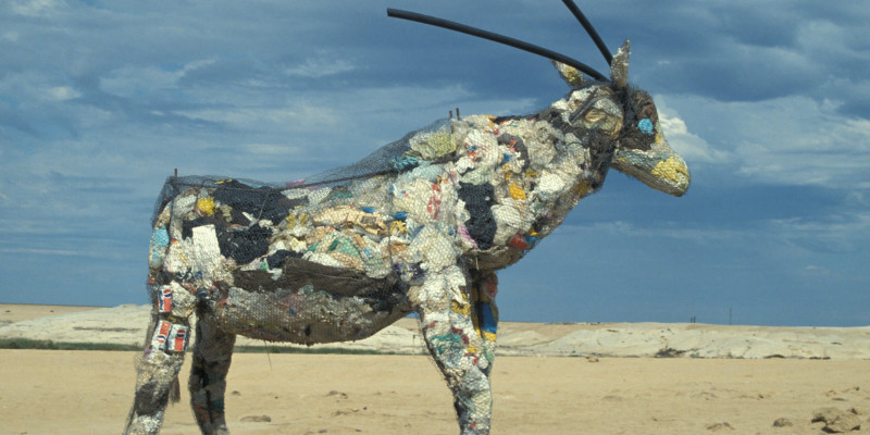 Eine Antilope aus Maschendraht gebaut und mit Müll gefüllt, die am Strand steht
