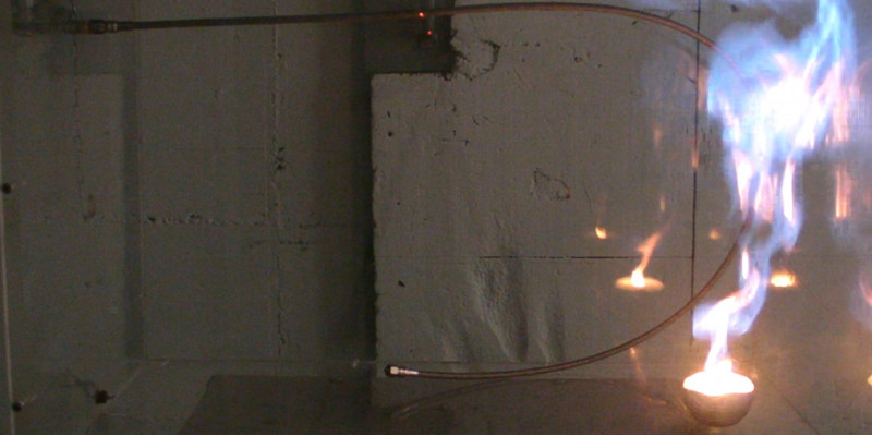 The photo shows that the fluorinated refrigerant 1234yf burned during the laboratory test.