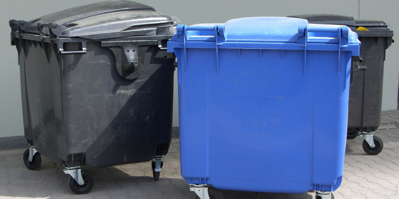 Three large garbage containers for waste paper and waste