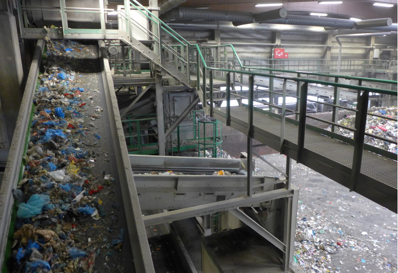 Mixed waste on a conveyer belt in a waste treatment plant