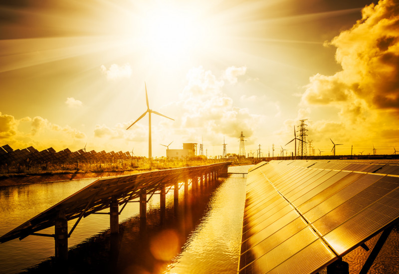 The picture shows solar panels as well as wind turbines.