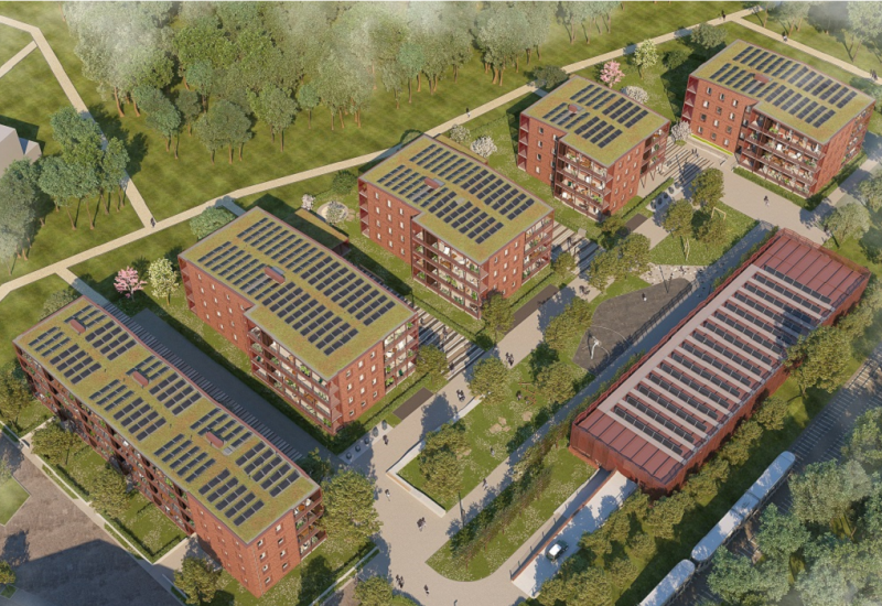 Vier Häuserblocks mit Fotovoltaik und Gründach aus der Vogelperspektive