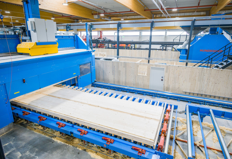 Holzelement in einer Maschine in einer Werkshalle 