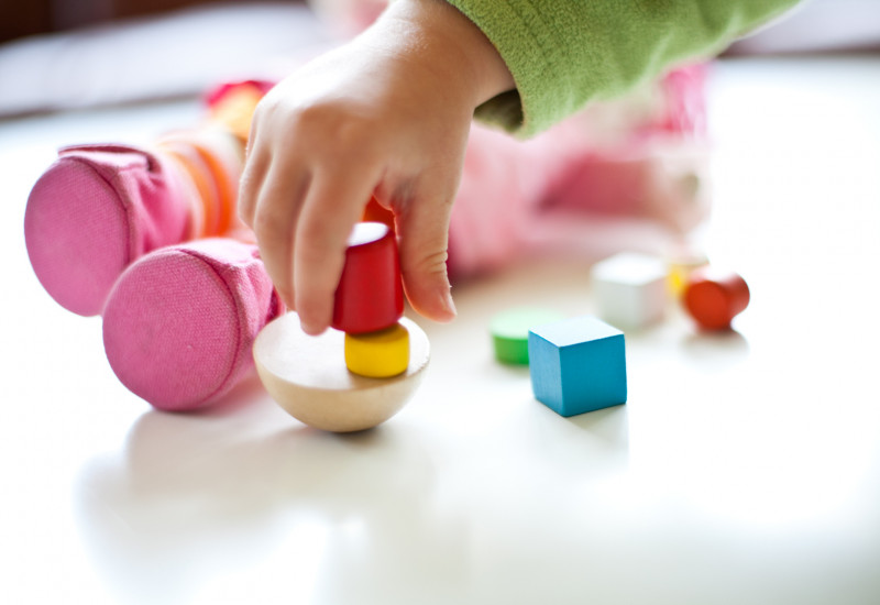 a child´s hand playing with toys