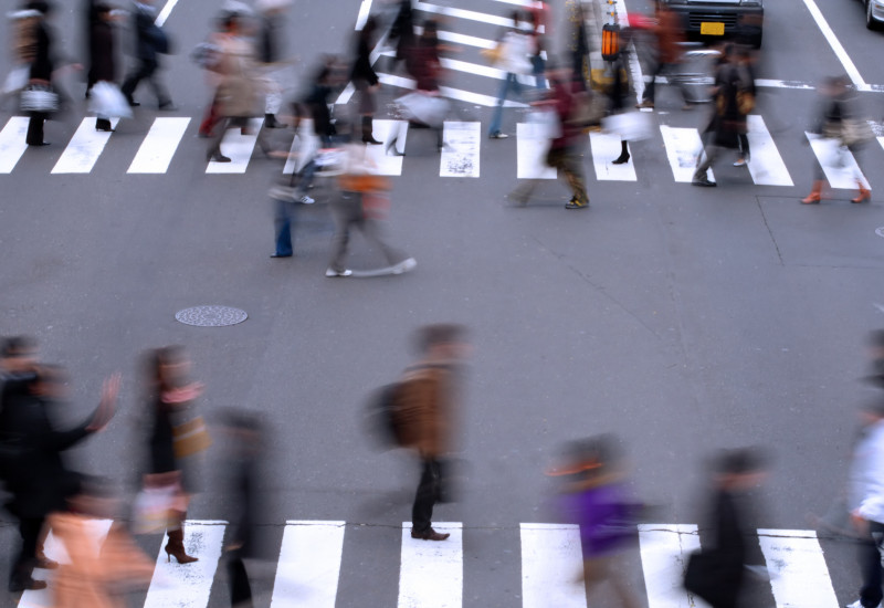 pedestrians are crossing a street on an cross-walk