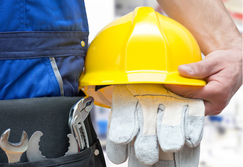 worker with tools and crash helmet