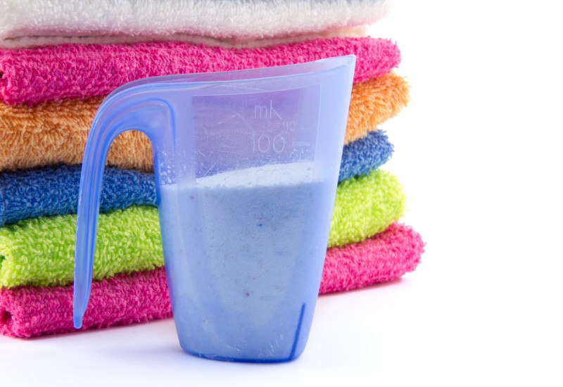 measuring cup for laundry detergent and towels in different colours