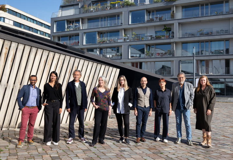 The jury posing in front of a building