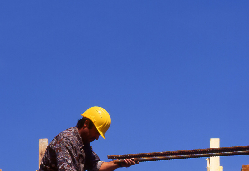 A construction worker lags a slab.
