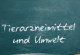 Foto einer Tafel mit dem Schriftzug „Tierarzneimittel und Umwelt“, darunter eine Hand mit Kreide, mit der ein horizontaler Strich auf die Tafel gemalt wurde.