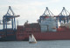 Sailing boat and container ship in the harbor of Hamburg