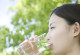a women is drinking a glass of water