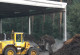 A yellow wheel loader implements composting in a composting plant.