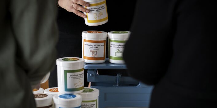 Dosen mit verschiedenen das Klima beeinflussenden Alltagshandlungen können auf die Klimawaage gestellt und so miteinander verglichen werden. 