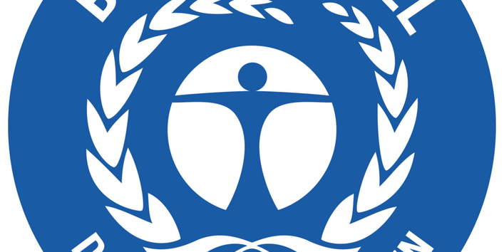 The "Blauer Engel" ecolabel, featuring a blue circular seal. Inside, there is a white stylized figure with outstretched arms surrounded by a laurel wreath. The words "BLAUER ENGEL" are at the top, and "DAS UMWELTZEICHEN" (The Ecolabel) is at the bottom.