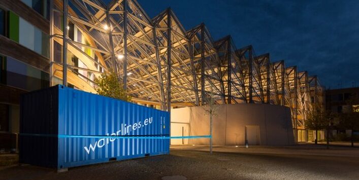 Nahaufnahme des "Seecontainers": ein blauer Container mit der Aufschrift "Waterlines.eu". Er beherbergt die Fotografien von Martin Jehnichen.