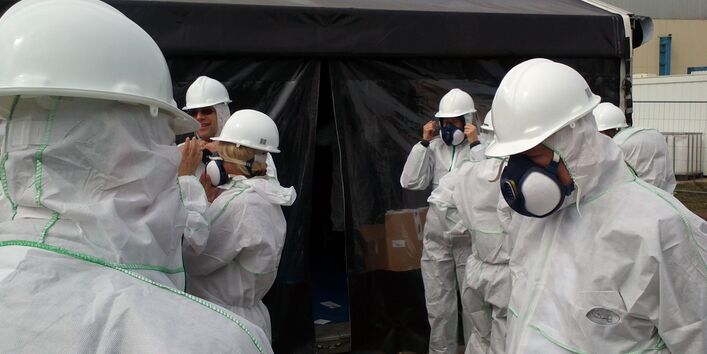 Wearing personal protective equipment while working at a contaminated site