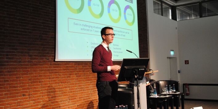 Dr. Christopher Andrey on a speaker's desk