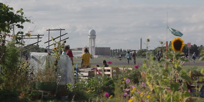 Ein Blumengarten direkt am Rand des Tempelhofer Flugfelds in Berlin, das als Parkt genutzt wird. 