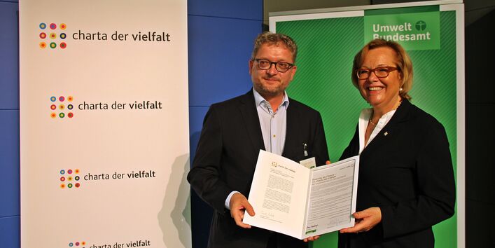 Zwei Personen mit der unterzeichneten Charta der Vielfalt