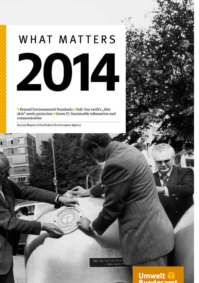 two man putting a sticker with the Blue Angel on a bottle bank