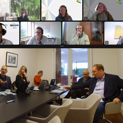 A screenshot  of a hybrid meeting, held in person and online.