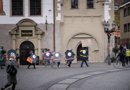 Das EMW-Maskottchen Edgar wird auf großen Platten durch die Stadt getragen