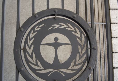 Tall black metal gateway with the eco-label