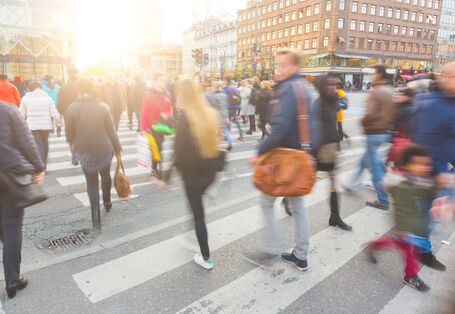 many pedestrians on a zebra crossing