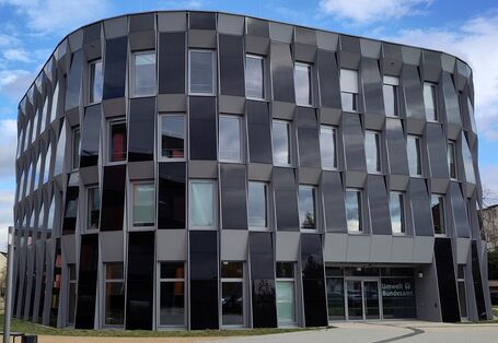 Vierstöckiges Gebäude mit Photovoltaik-Elementen an der Fassade 