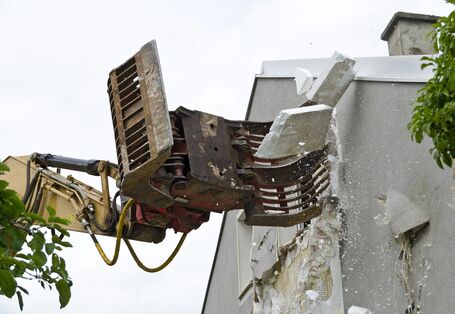 polystyrene insulation materials are removed from a facade