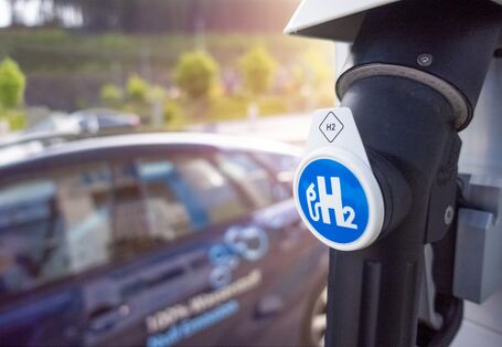 ein Auto steht an einer Tankstelle, auf dem Zapfhahn steht H2