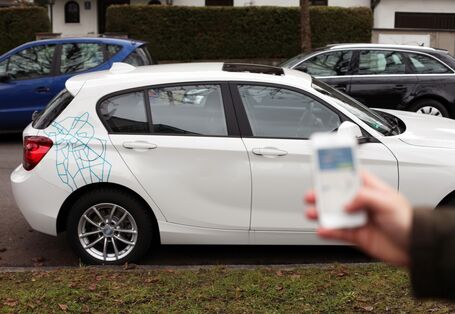 car and man with mobile phone