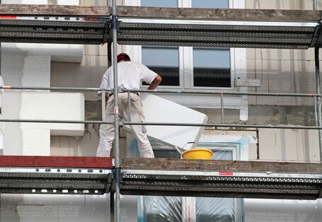 Builders insulating a house
