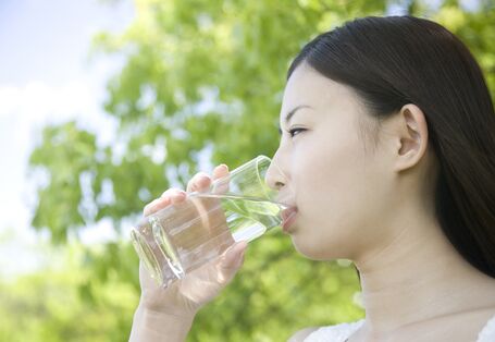 a women is drinking a glass of water