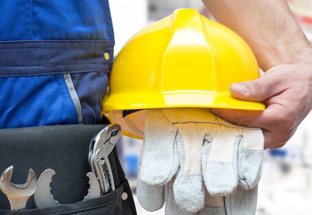 worker with tools and crash helmet