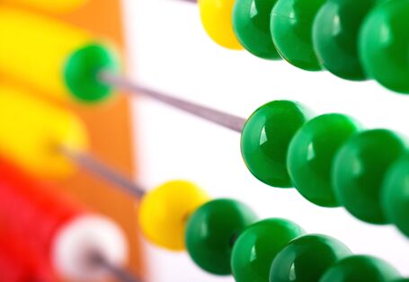 Rechenschieber mit grünen Kugeln im Vordergrund.