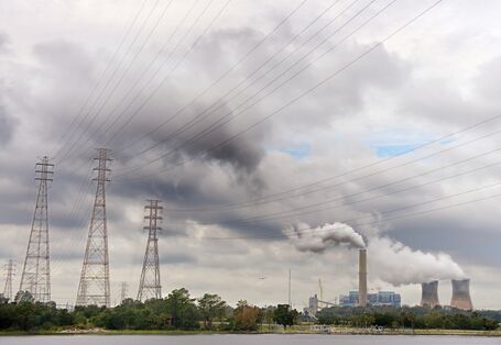 Cloudy landscape with power lines and power plant