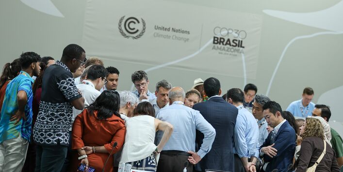 Vertreter*innen verschiedener Länder stecken die Köpfe zusammen und beraten sich auf der COP30 in Brasilien.