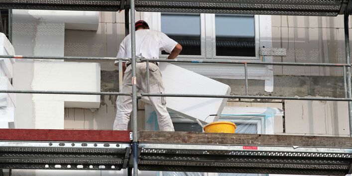 Builders insulating a house